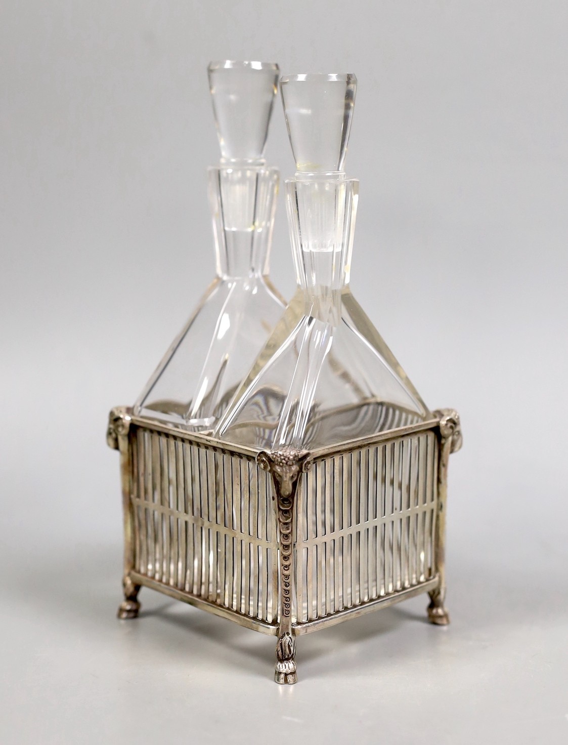 A boxed George V silver oil and vinegar stand, by Reid & Sons, London, 1911, with two Steuban glass bottles with stoppers, height 17.8cm.